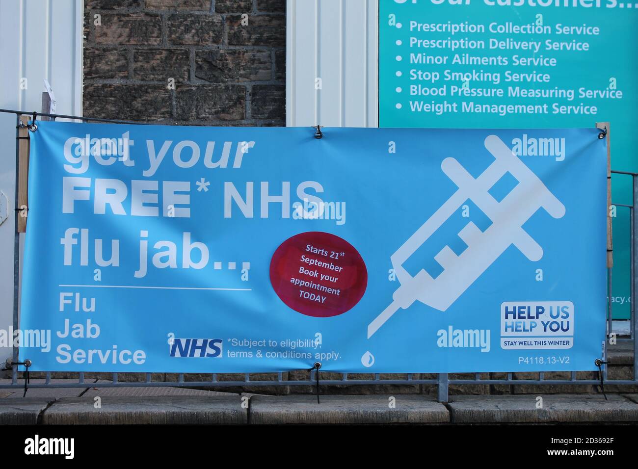 Flu jab sign outside pharmacy in UK Stock Photo