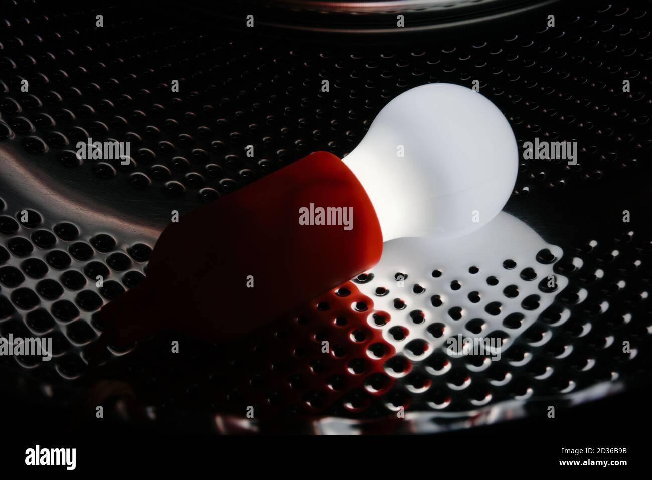 Lamp bulb on a metallic pattern Stock Photo