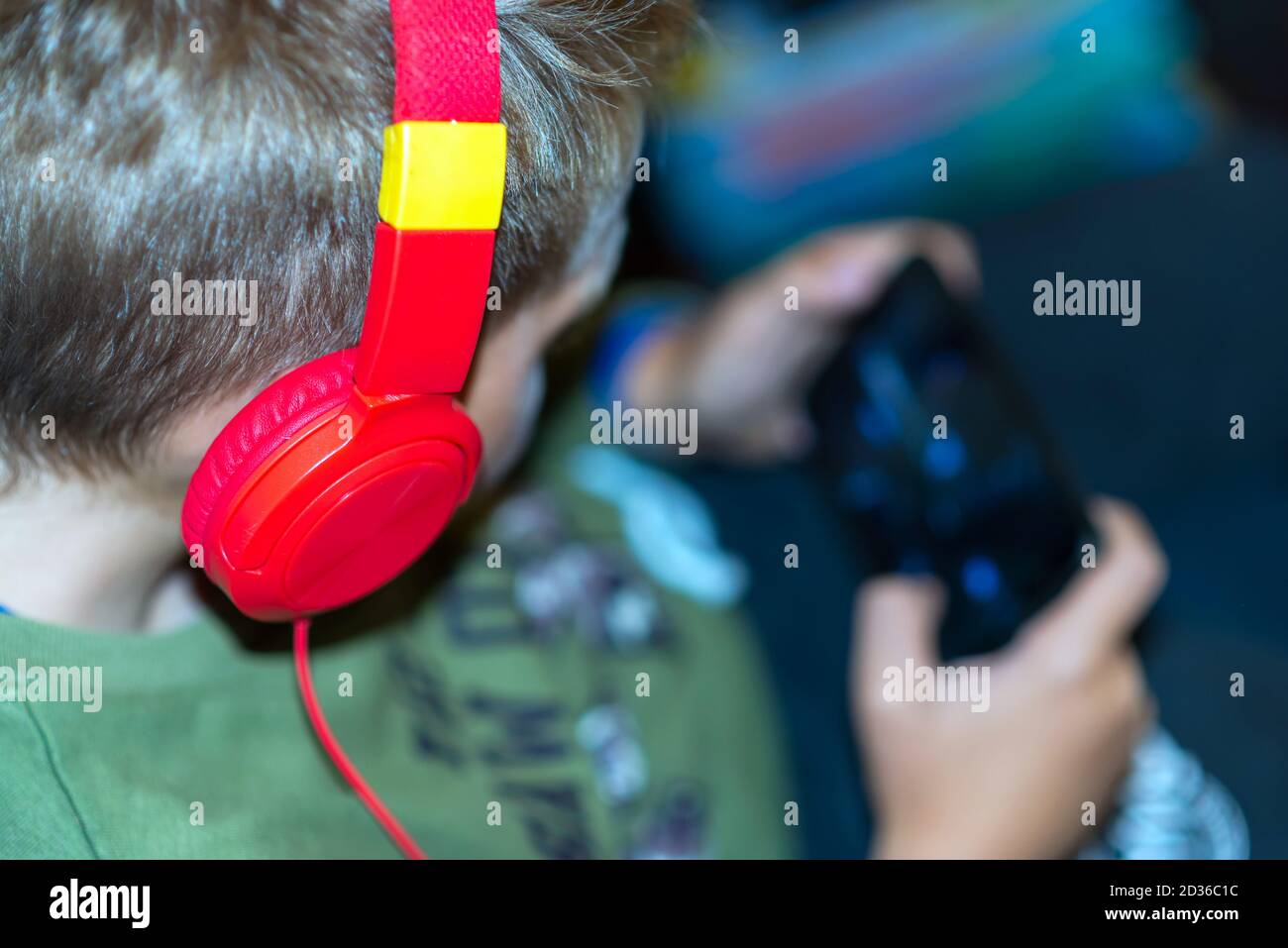 Close up top view school boy 9s calm surprised Face on Smart phone watching movie or feelings in the his game Stock Photo