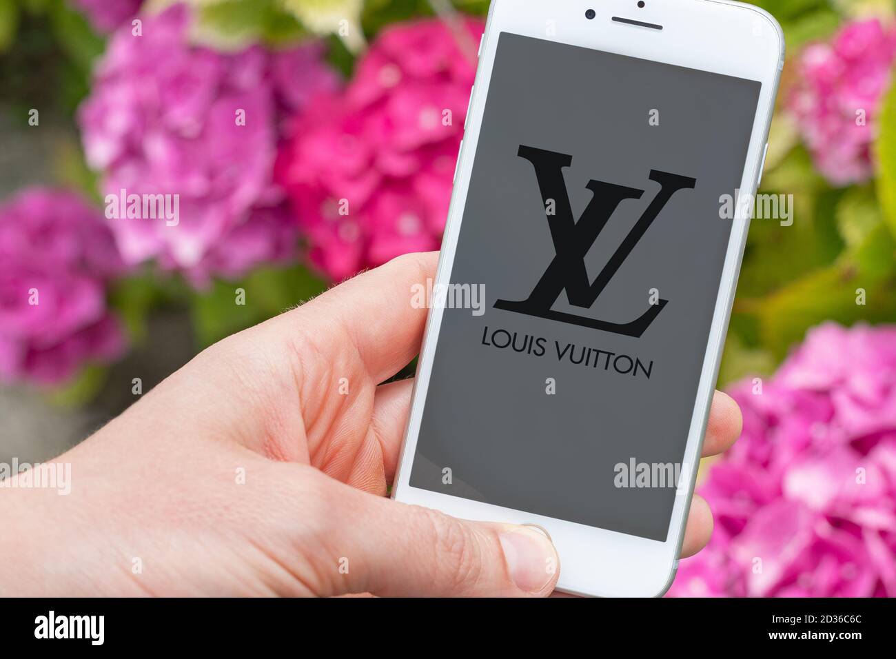 Guilherand-Granges, France - October 07, 2020. Person holding smartphone with Louis Vuitton logo. Louis Vuitton is a French fashion house and luxury g Stock Photo