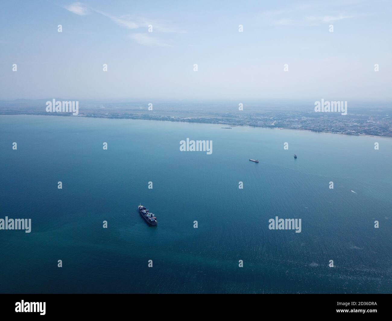 Georgetown, Penang/Malaysia - Mar 17 2020: A container ship at Penang sea. Back is Peninsular Malaysia. Stock Photo