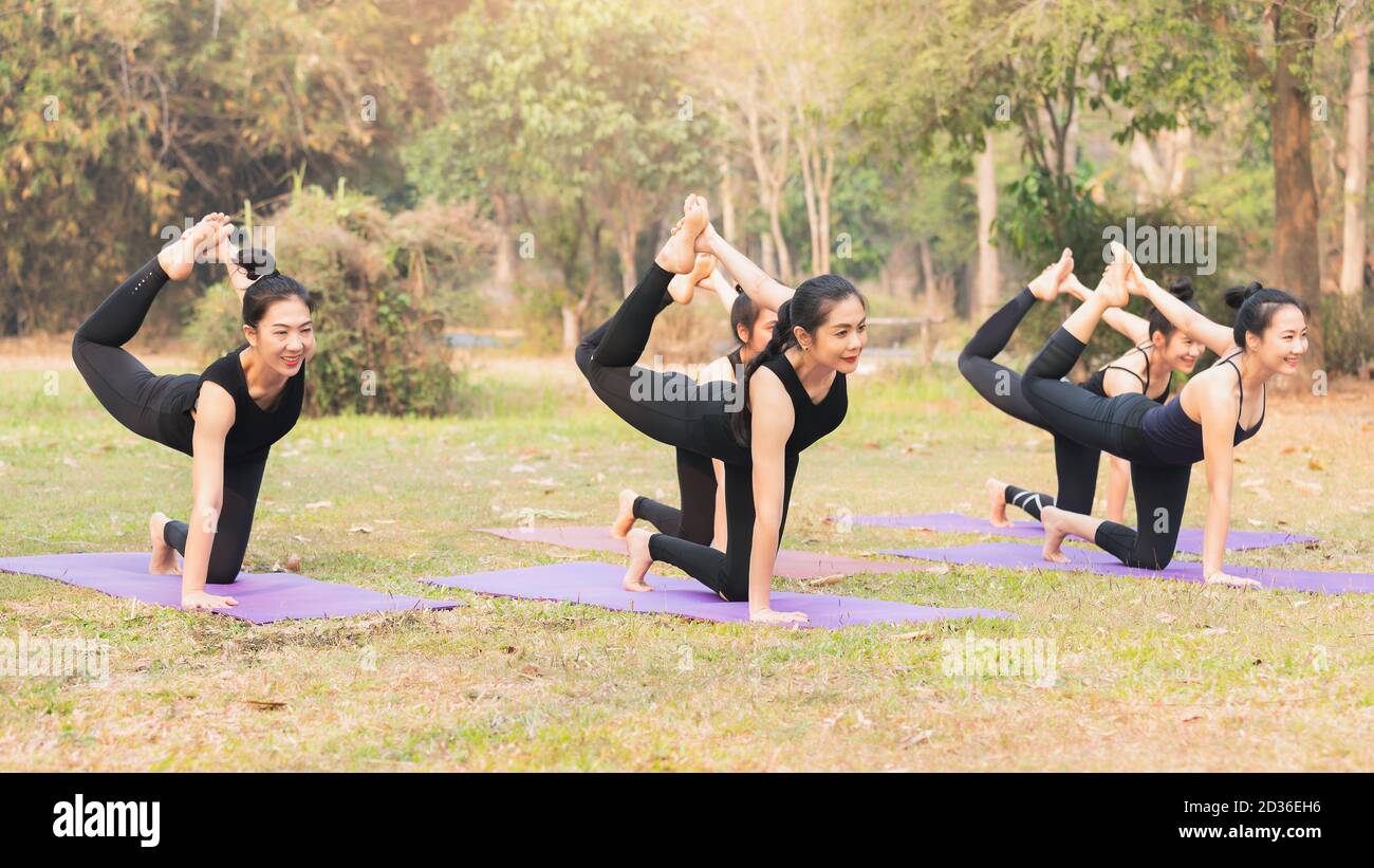 Group of asian women doing yoga beside the lake in outdoor park Stock ...