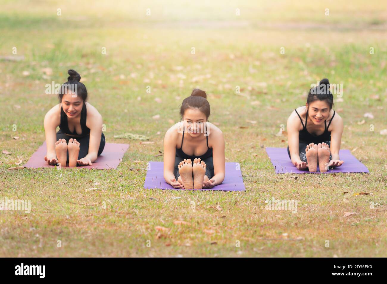 Group of asian women doing yoga beside the lake in outdoor park Stock ...