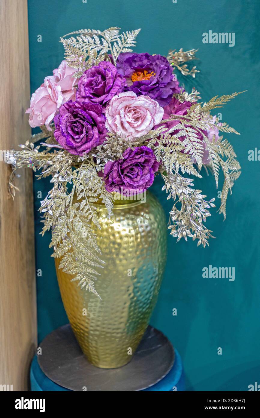 Artificial Flowers in Gold Vase at Room Corner Stock Photo - Alamy
