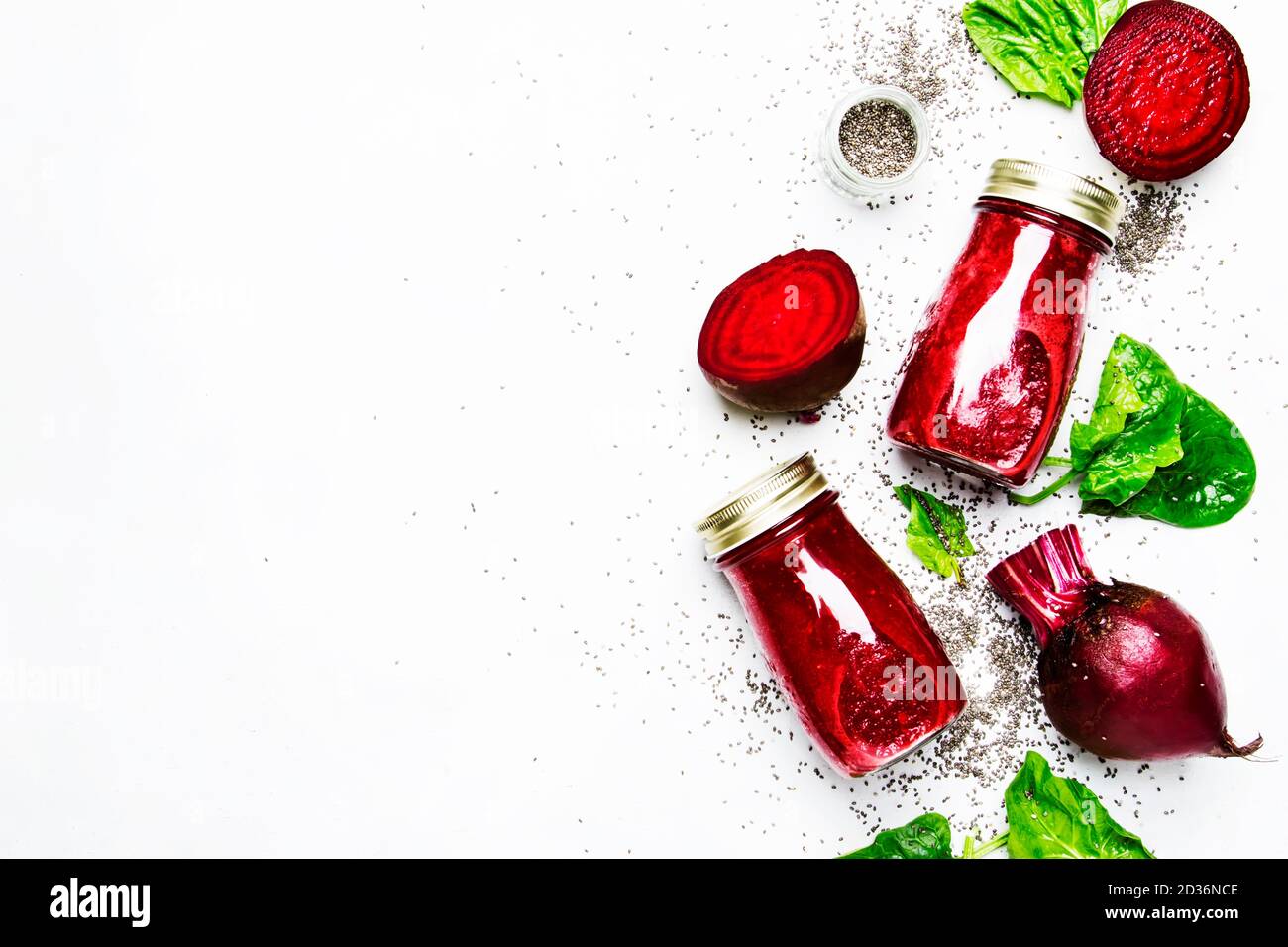 Delicious beetroot smoothies in glass bottles with chia on white food ...