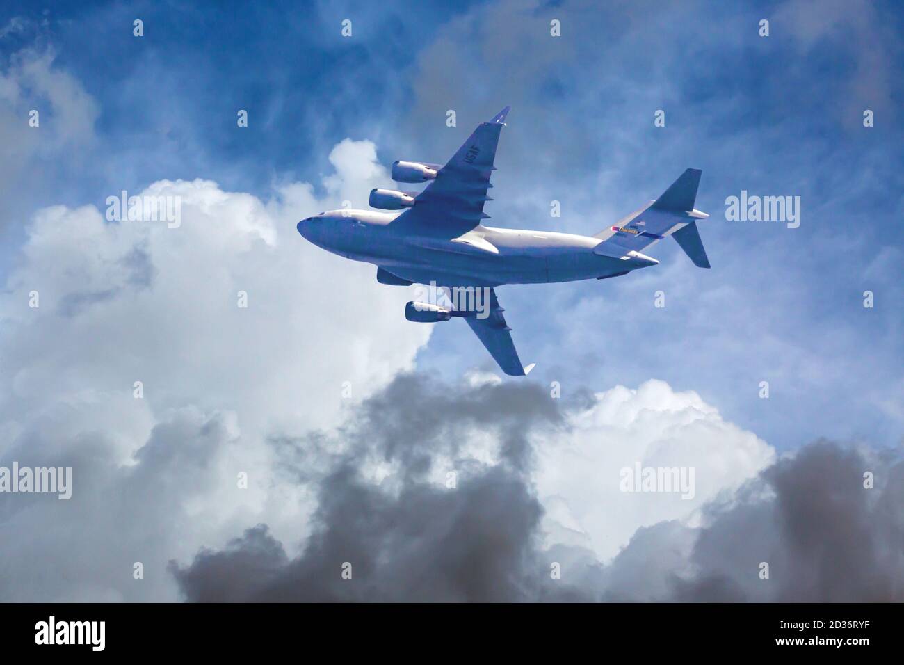 A C-17 Globemaster III cargo jet flies at low altitude after liftoff from Charlotte-Douglas International Airport.  The Jet is part of the 145 Airlift Stock Photo