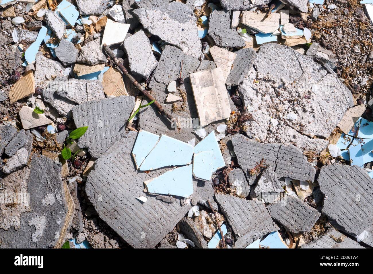 Debris, broken concrete panels, tiles on a sunny day, top view. Stock Photo