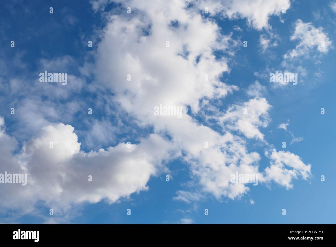 Cumulus clouds on blue sky in sunny spring day, nature background Stock Photo