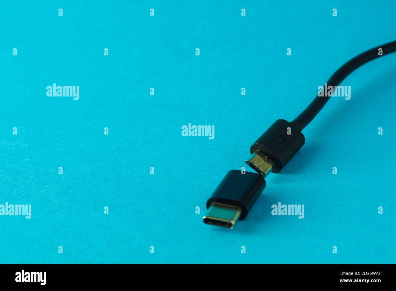 Micro USB to Type C small adapter and cable on blue background, selective focus, copy space Stock Photo