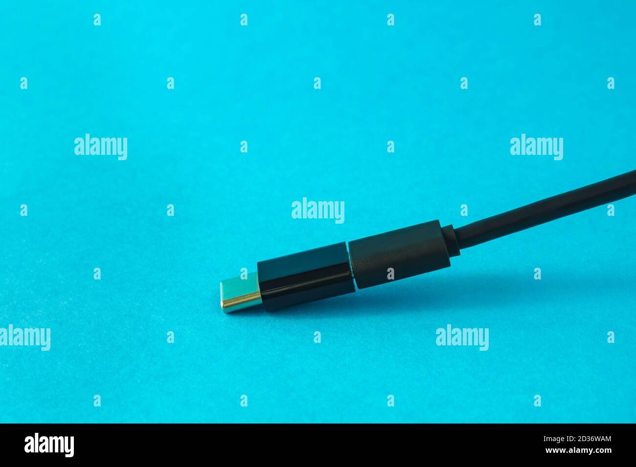 Micro USB cable with small adapter to Type C on blue background, selective focus, copy space Stock Photo