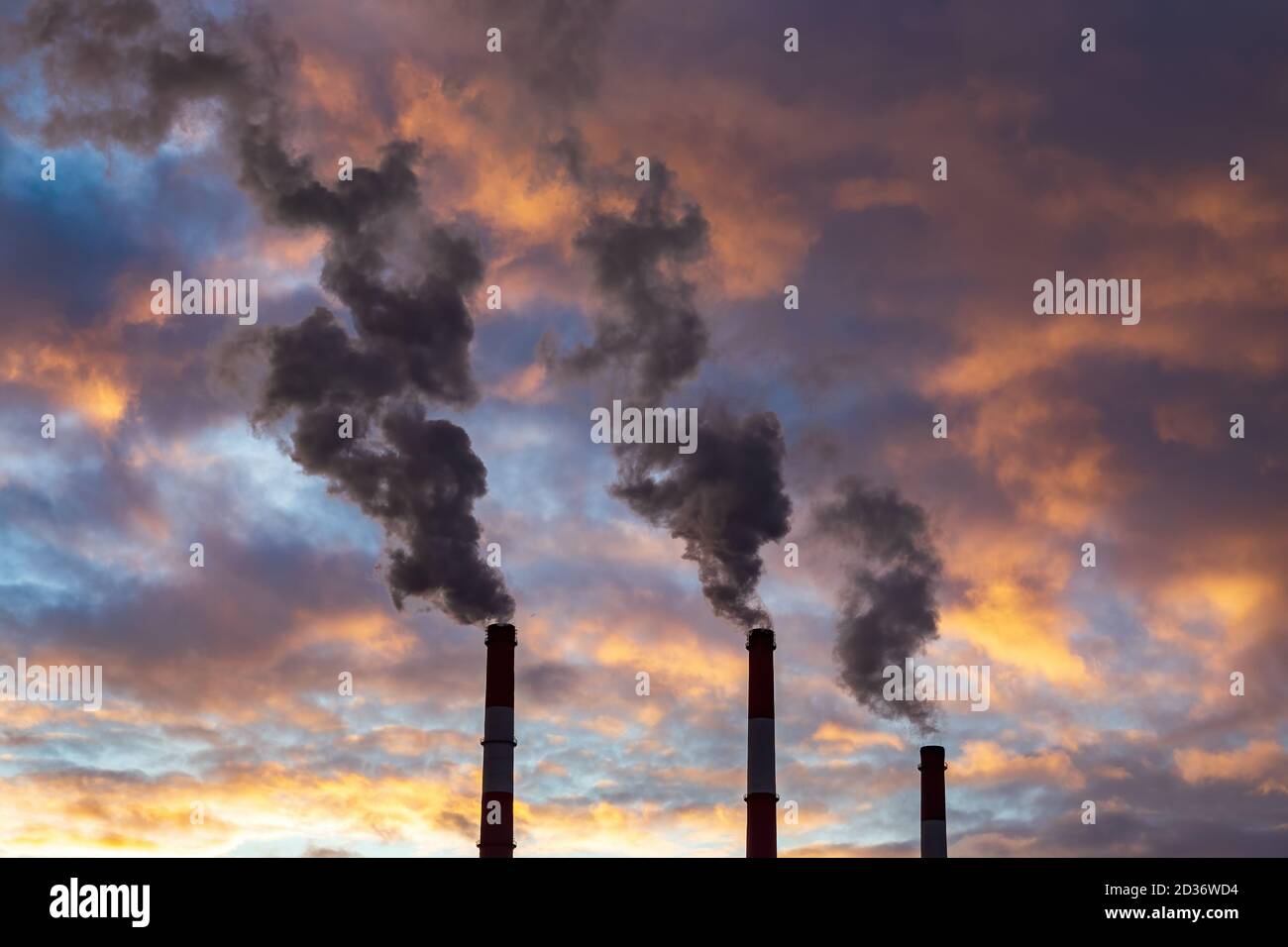 Three chimneys smoke on dramatic colorful sky background. Industry pipes. Air  pollution concept Stock Photo - Alamy