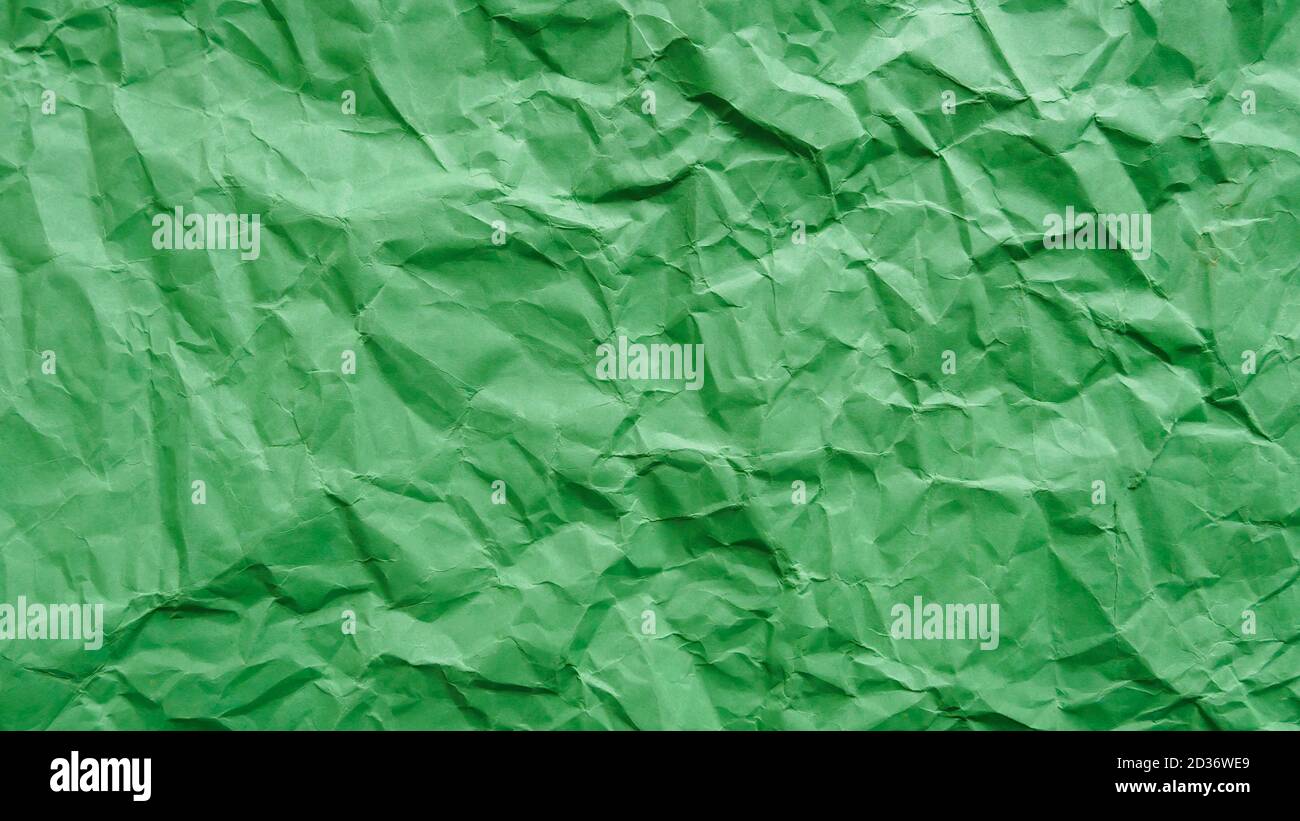 Crumpled green recycled paper, abstract background, copy space Stock Photo