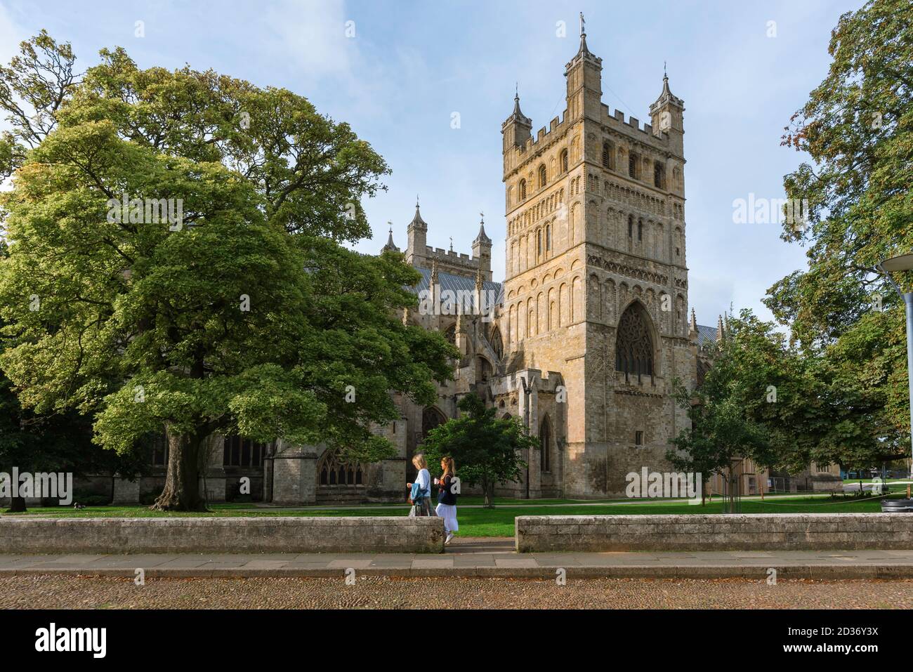 Women friends, view of two female friends exploring the grounds of the early medieval cathedral in the city of Exeter, Devon, England, UK Stock Photo