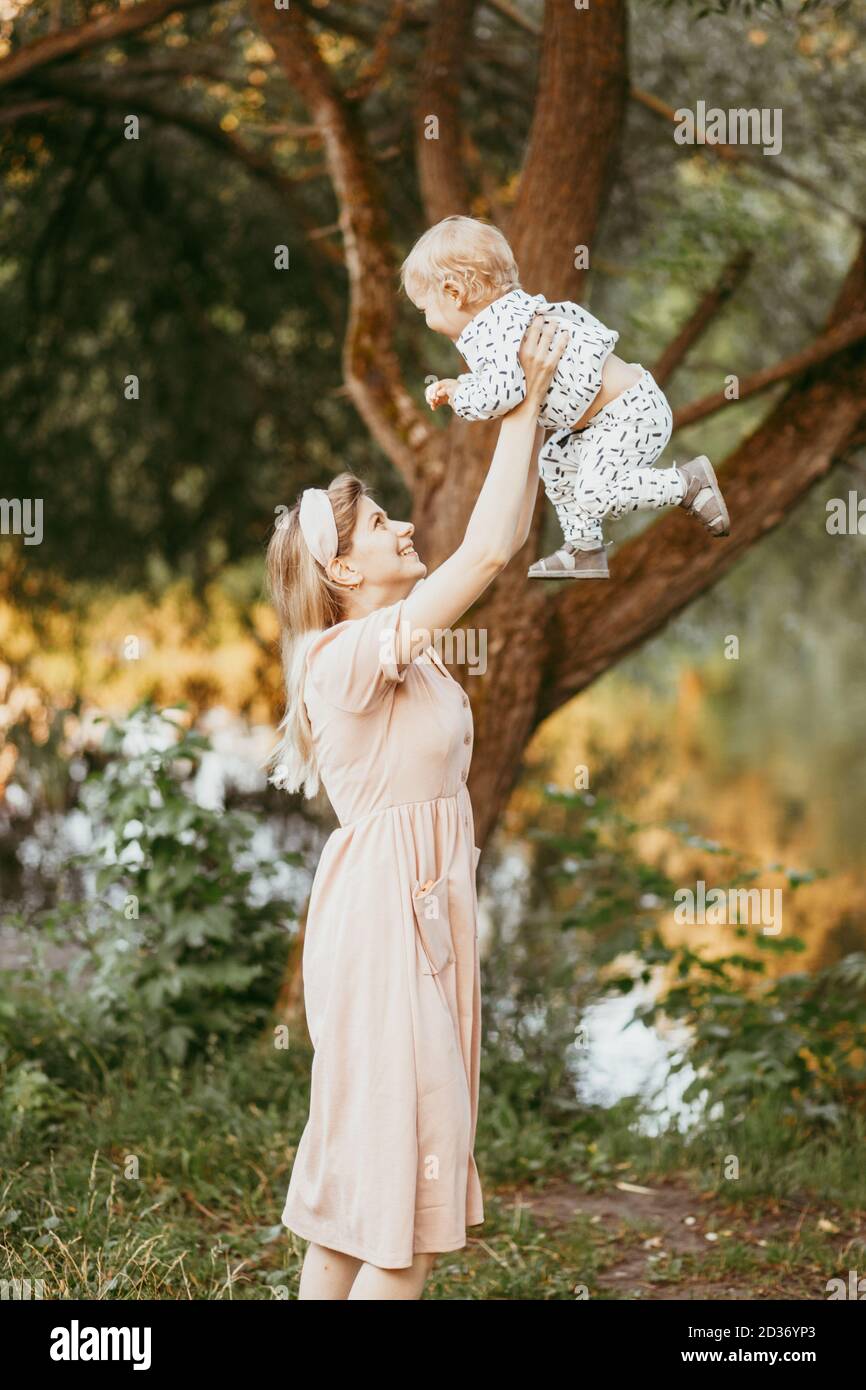 A mother holds her son in her arms on a summer day Stock Photo - Alamy
