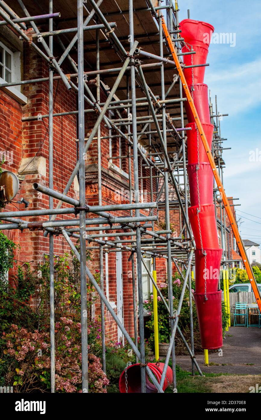 Scaffolding and rubbish chute on exterior of private house in