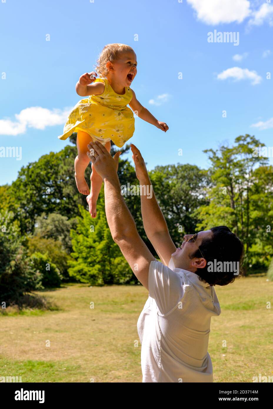 Man throwing happy baby in the air Stock Photo Alamy