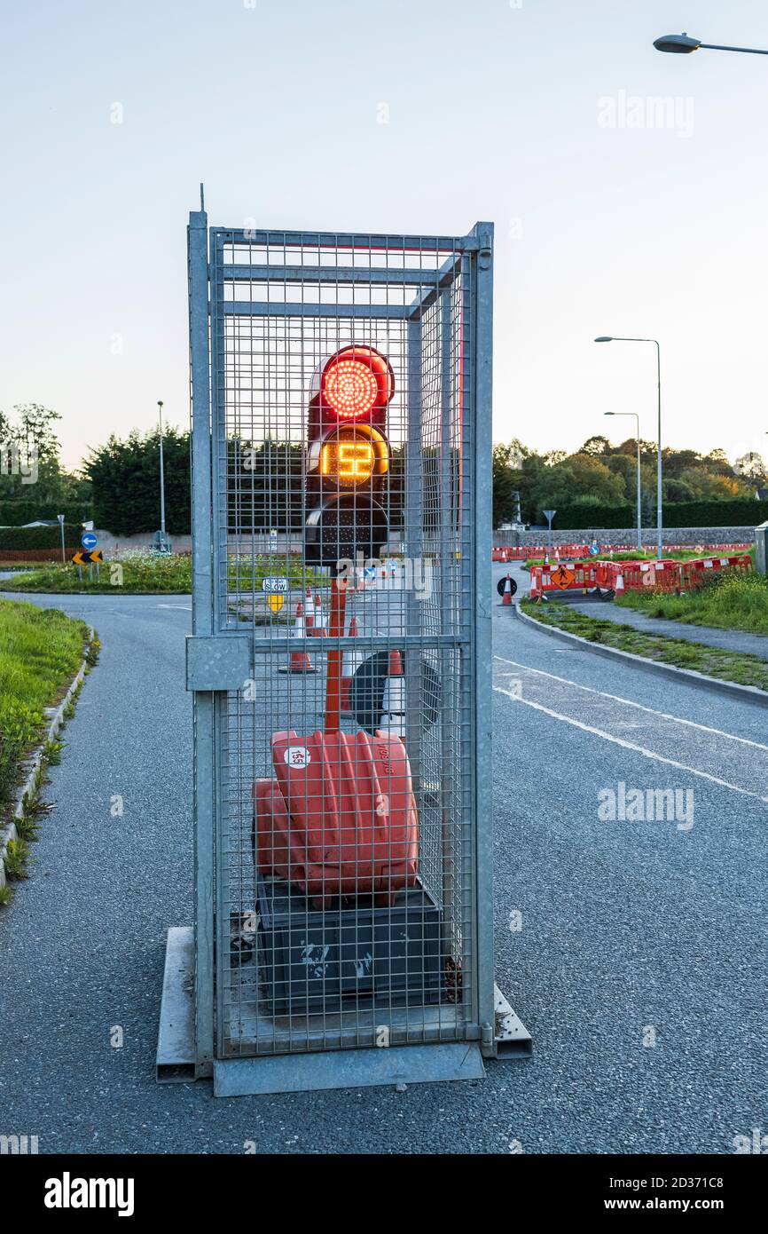 Temporary traffic lights in a cage, portable unit, at roadworks on the Sallins road at Johnstown, County Kildare, Ireland Stock Photo