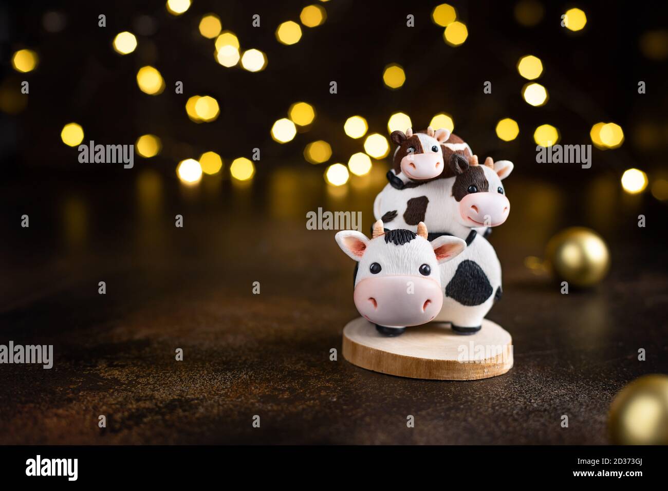family of bulls against Christmas lights and balls. Stock Photo