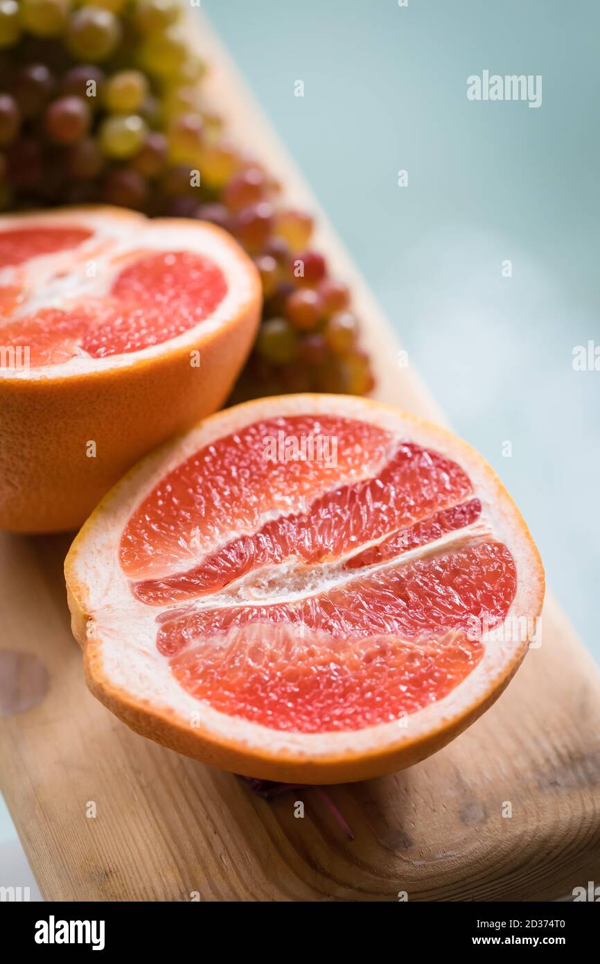Healthy Organic Red Ruby Grapefruit on wooden background, toned Stock Photo