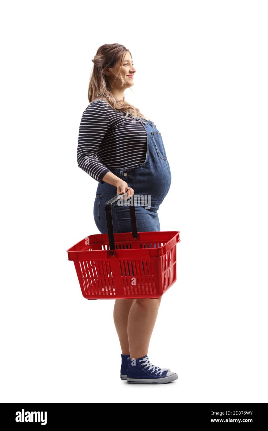 Full length shot of a smiling pregnant woman holding a shopping basket isolated on white background Stock Photo