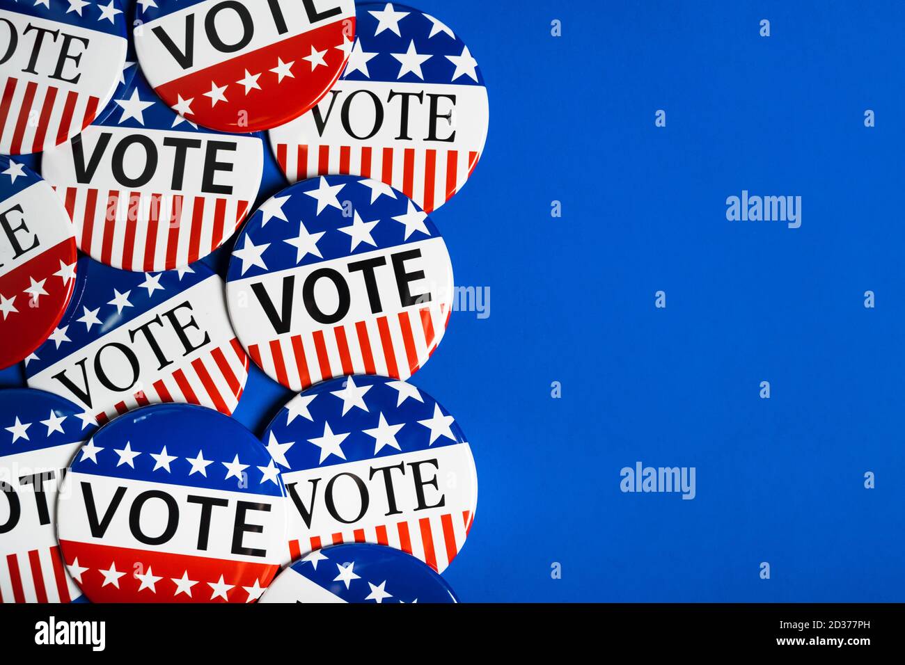 A group of red, white and blue VOTE button on a blue background Stock Photo