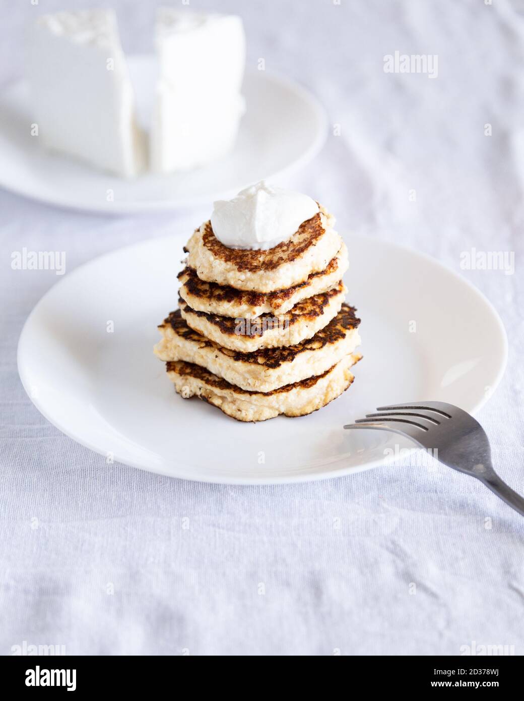 Cottage cheese pancakes from the traditional Cypriot Anari cheese with sour cream. Stock Photo