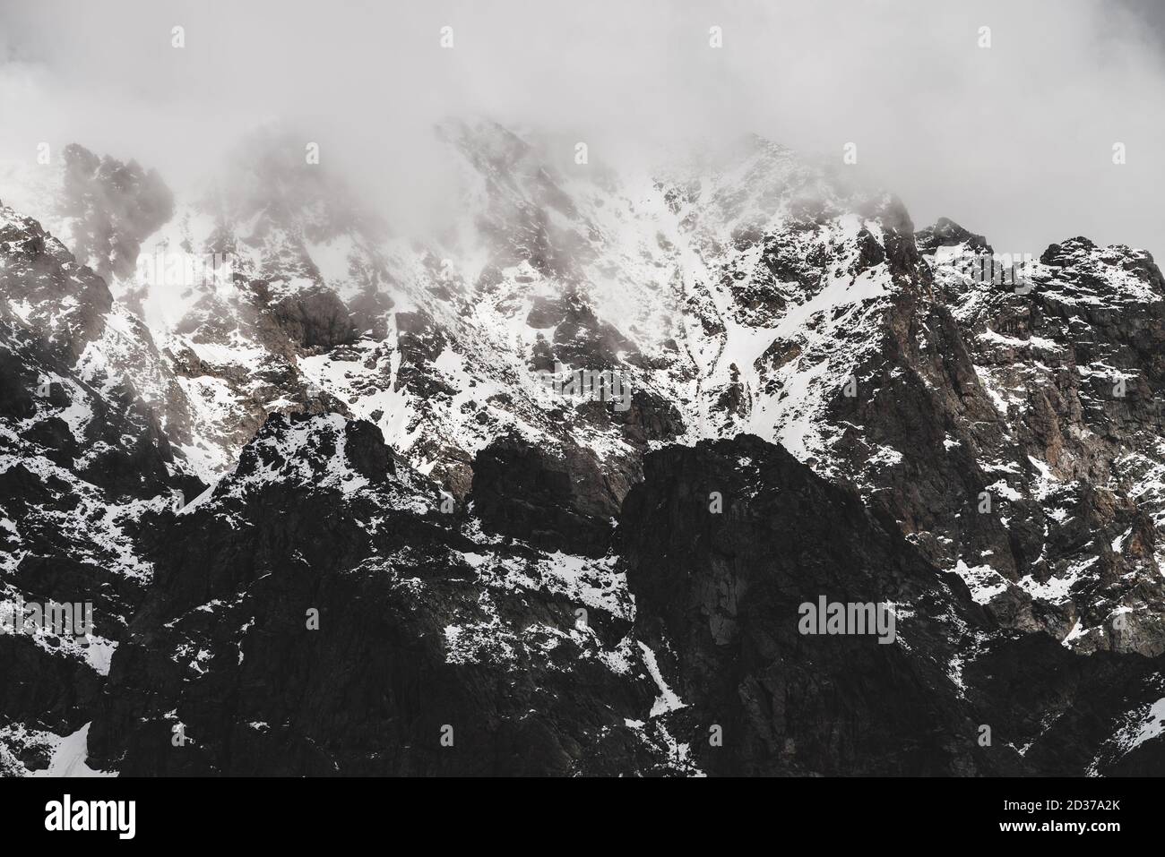 Atmospheric Minimalist Alpine Landscape With Snowy Rocky Mountain Peak Low Clouds Near Snowbound Range Rocks With Snow In Mist Craggy Mountains In Stock Photo Alamy Atmospheric Minimalist Alpine Landscape With Snowy Rocky Mountain Peak Low Clouds Near Snowbound Range Rocks With Snow In Mist Craggy Mountains In Stock Photo Alamy