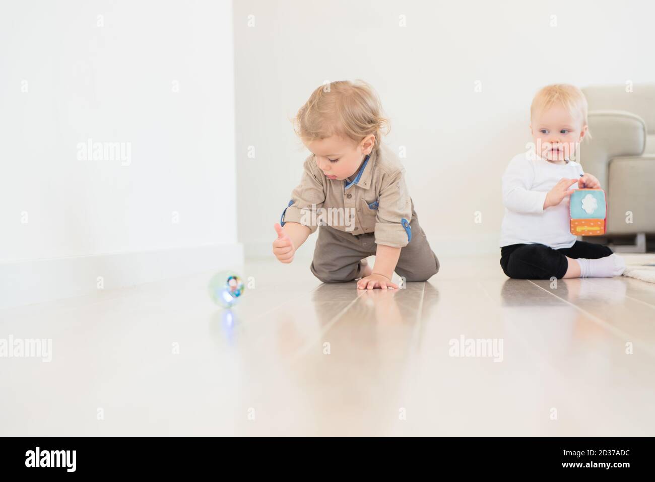 Cute little girl and boy playing with toys at home Stock Photo - Alamy