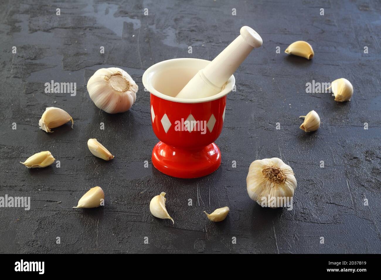Garlic in mortar and pestle on a black background Stock Photo Alamy