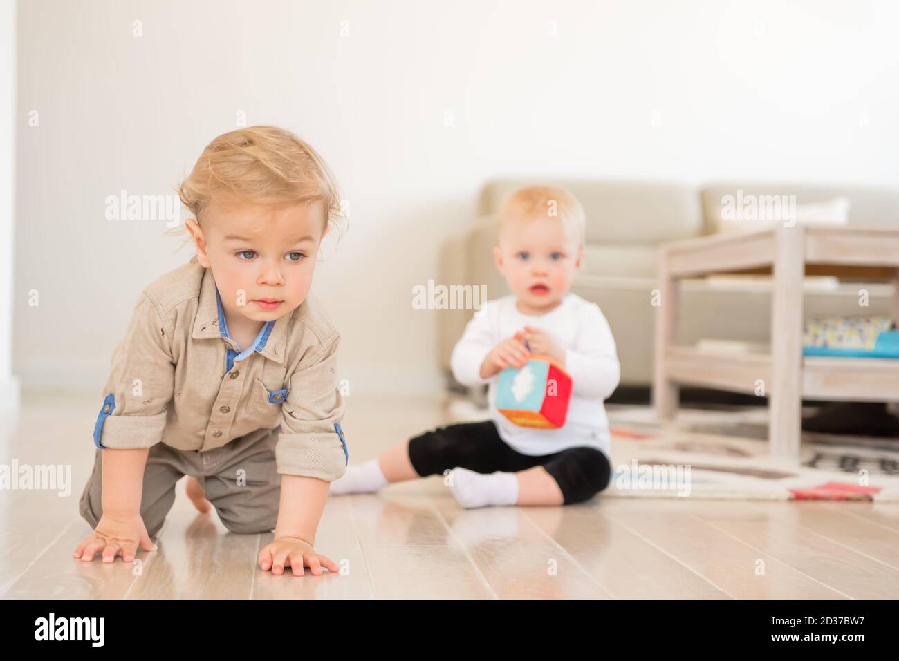 Cute little girl and boy playing with toys at home Stock Photo - Alamy