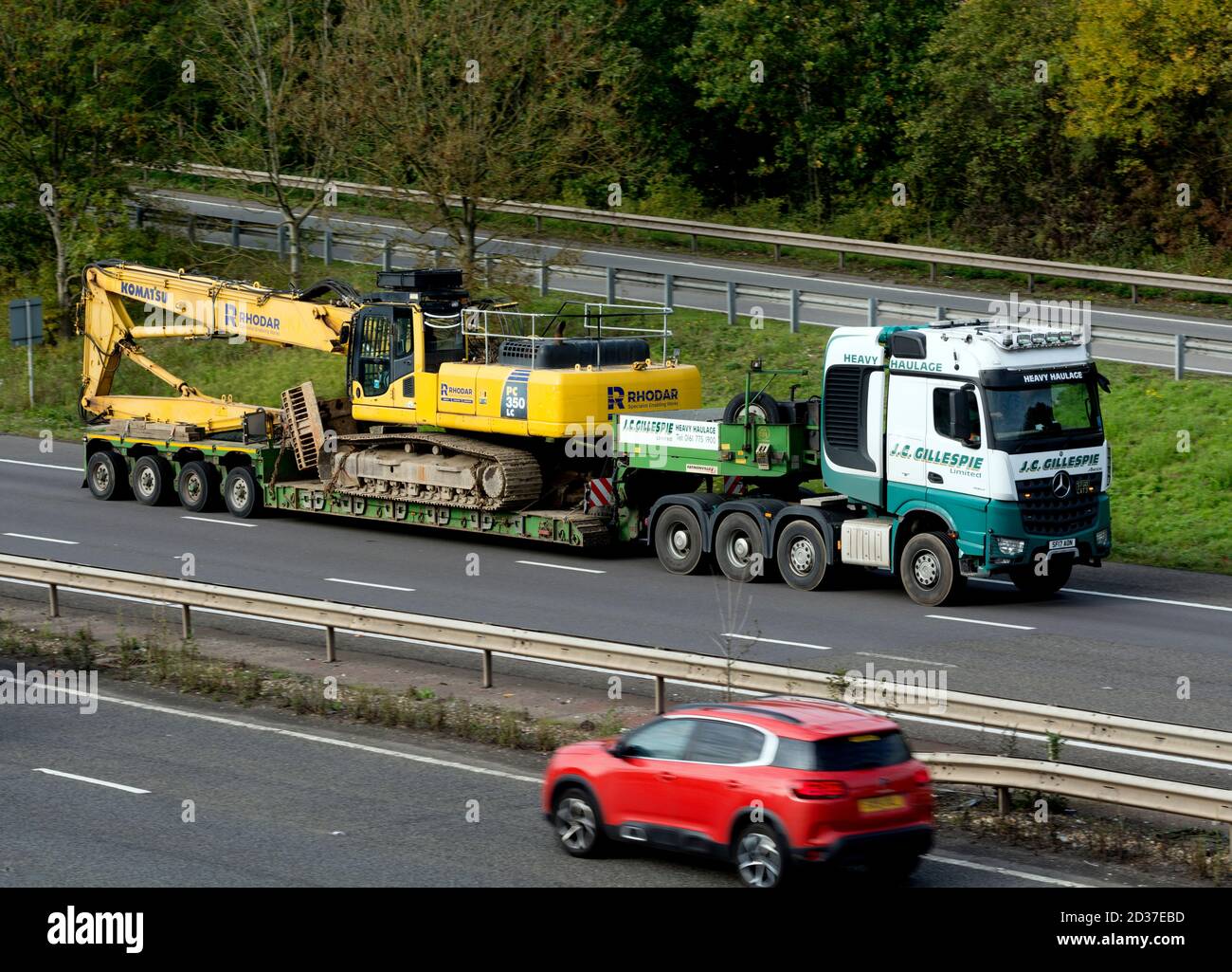 A large load on a low-loader lorry on the M40 motorway, Warwickshire, UK Stock Photo