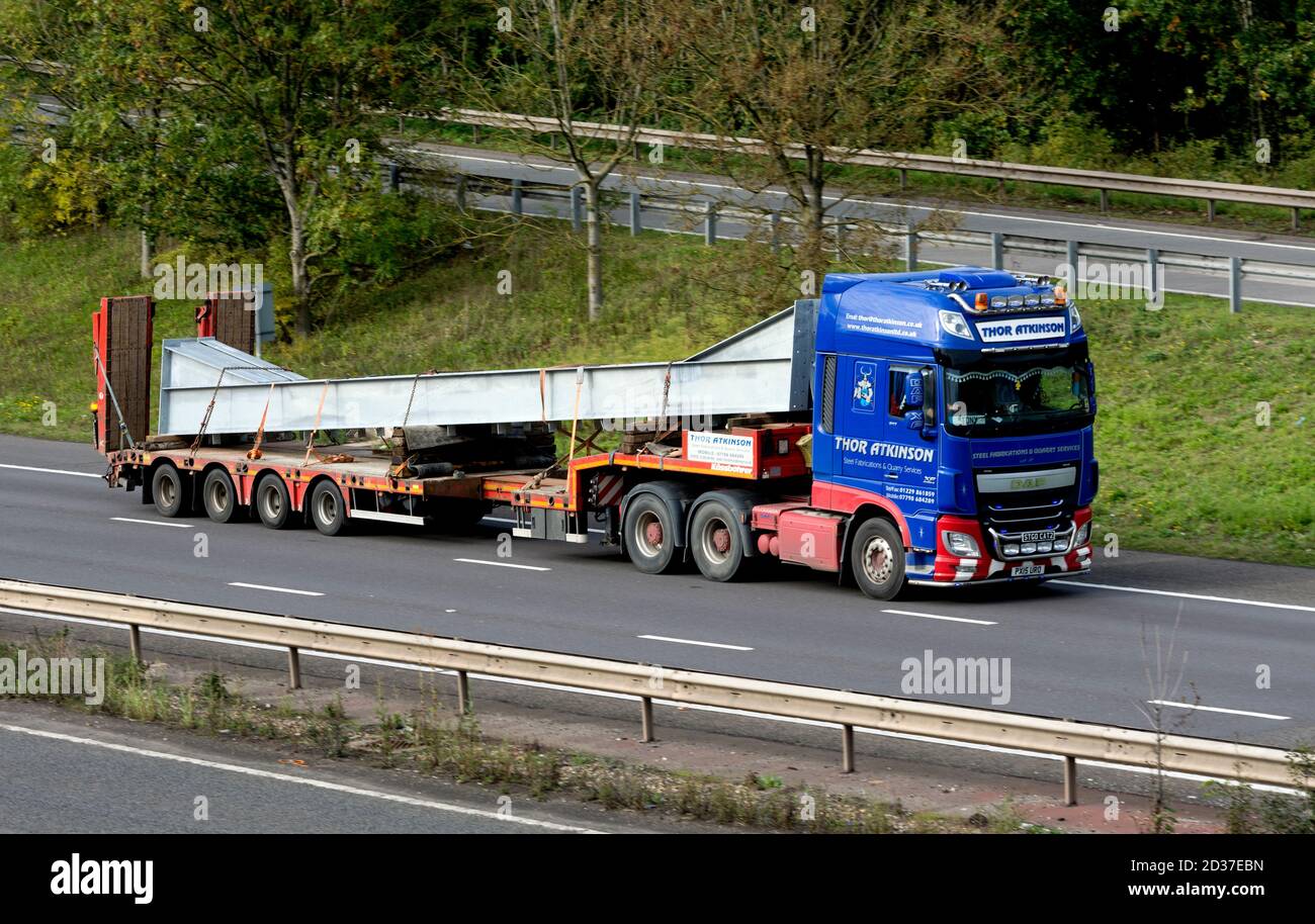 A large load on a low-loader lorry on the M40 motorway, Warwickshire, UK Stock Photo