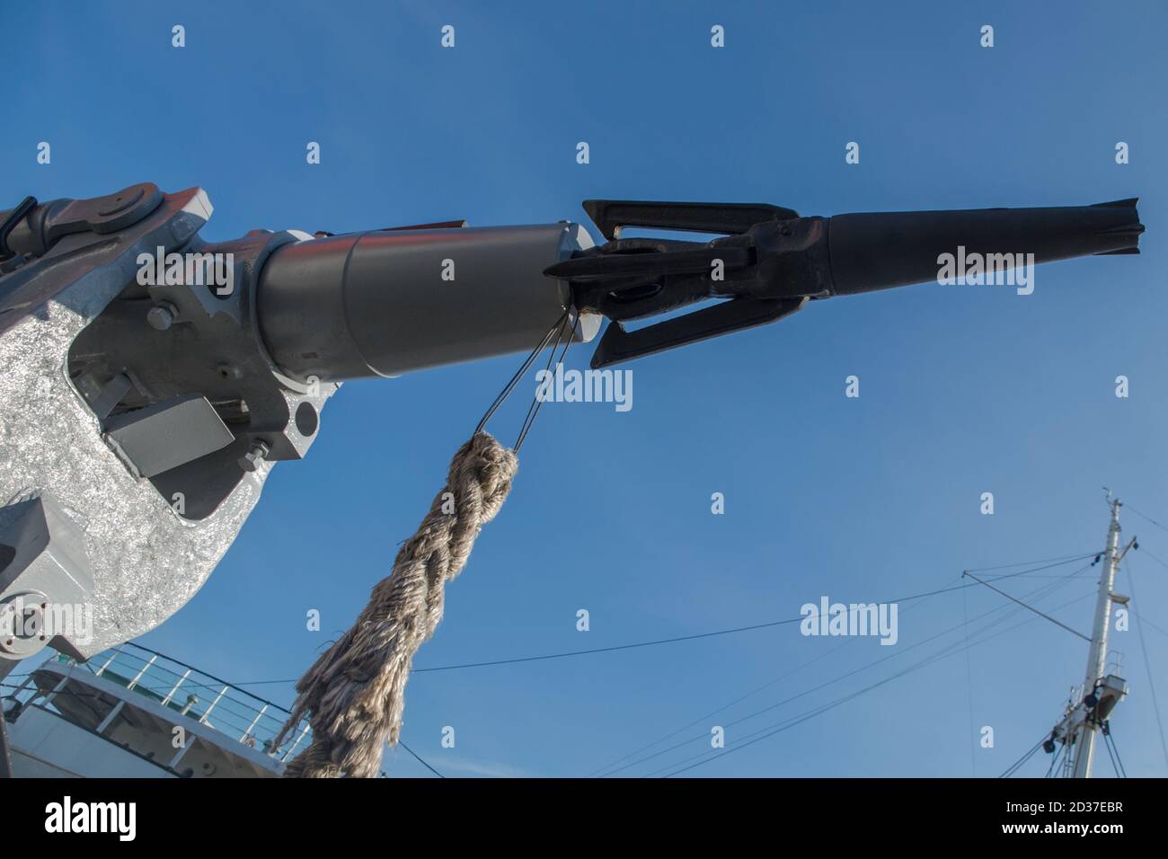 https://c8.alamy.com/comp/2D37EBR/gray-cannon-harpoon-with-black-tip-mounted-in-mouth-holder-with-braided-rope-attached-to-it-against-blue-sky-and-fragment-of-top-of-deck-and-mast-2D37EBR.jpg