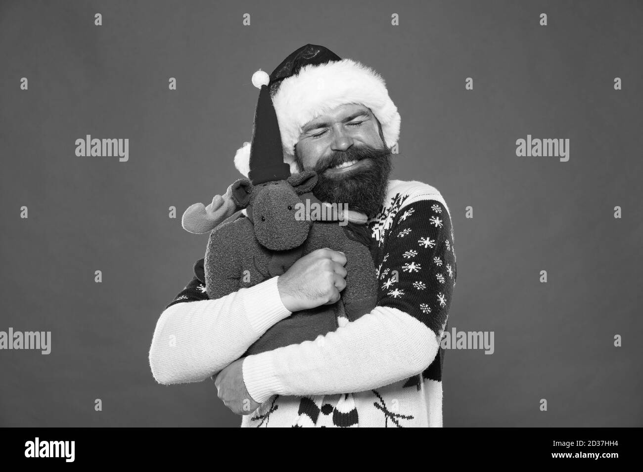 With love. Bearded man hug soft toy. Happy hipster embrace Christmas present. New year hug. Holiday hug. Happiness is a warm hug. Stock Photo