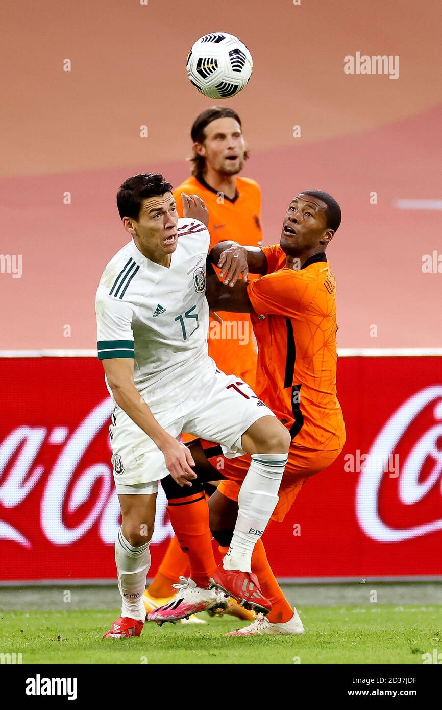Amsterdam, Netherlands. 07th Oct, 2020. AMSTERDAM, 07-10-2020, JohanCruyff Arena, friendly game between Netherland and Mexico. Mexico player Hector Moreno (L) and Netherlands player Georginio Wijnaldum (R) during the game Netherlands - Mexico. Credit: Pro Shots/Alamy Live News Stock Photo