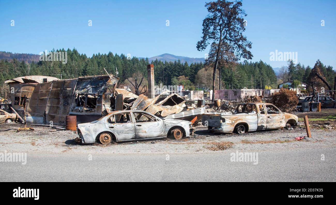 Gates,OR ,September 27 2020 USA:  After a fire raced thru the town of Gates OR earlier in the month, huges amounts of twisted steel and burned out car Stock Photo