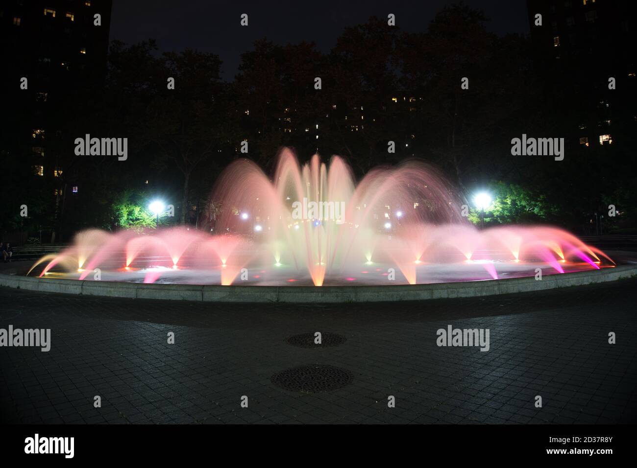 Red and orange colored water fountain at night Stock Photo Alamy