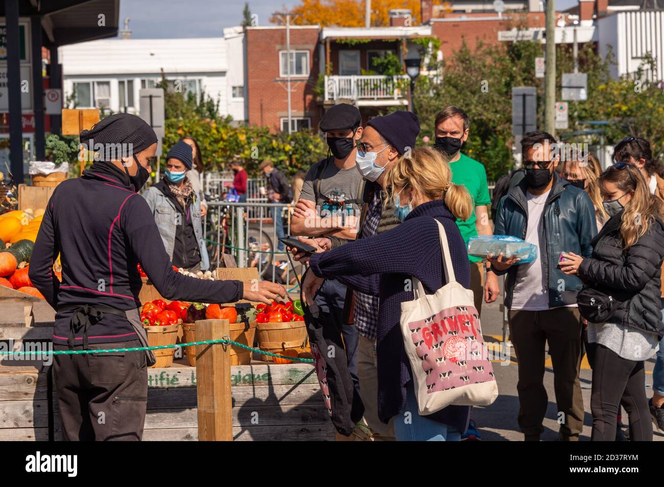 Montreal, CA - 4 October 2020: market seller and customers wearing Coronavirus face masks at Marche Jean Talon Market Stock Photo