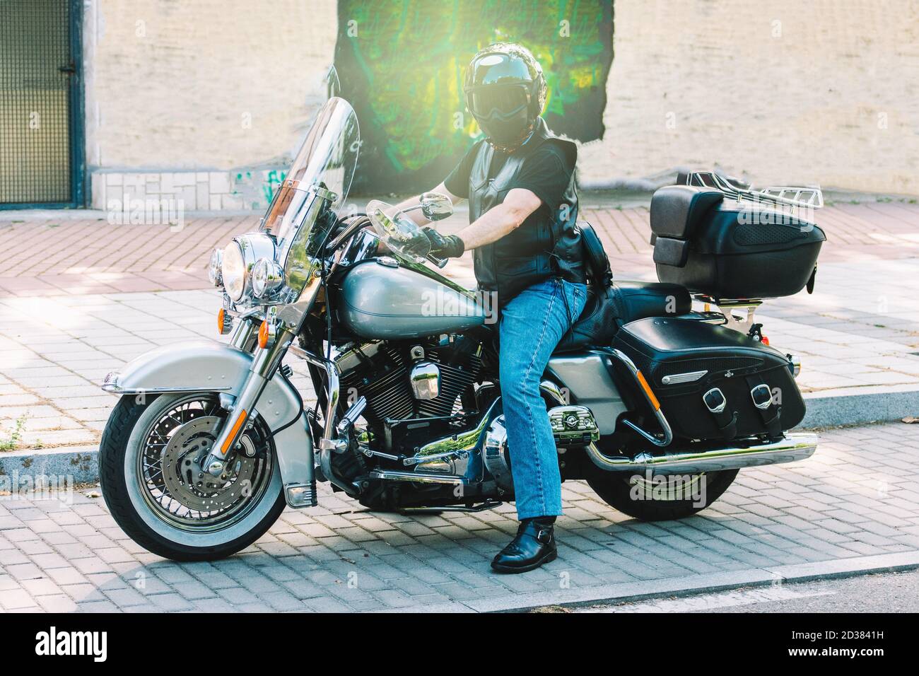 biker posing with on his custom motorcycle Stock Photo