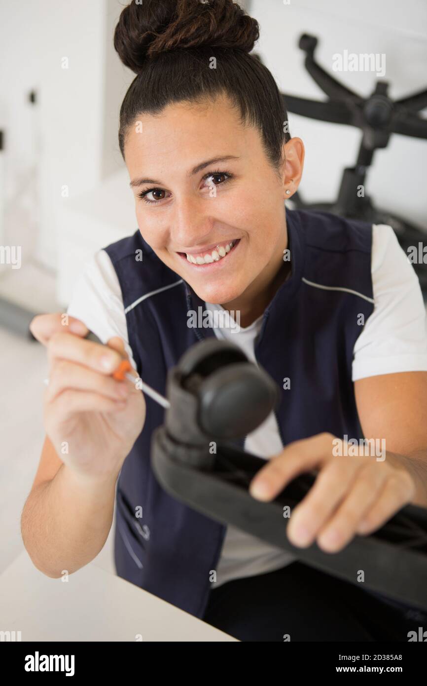 female worker fixing a chair Stock Photo - Alamy