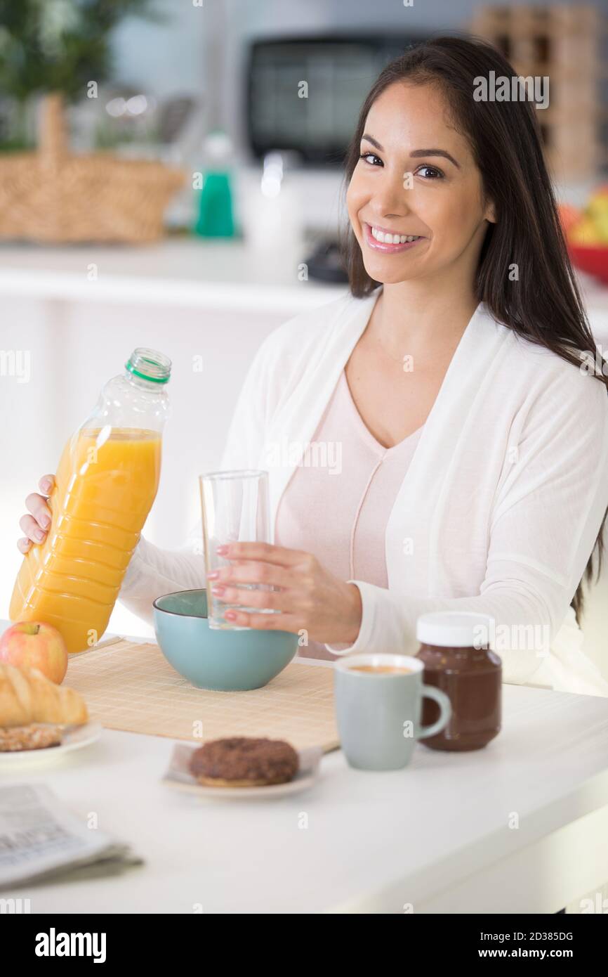 pretty woman drinking orange juice in the morning Stock Photo Alamy