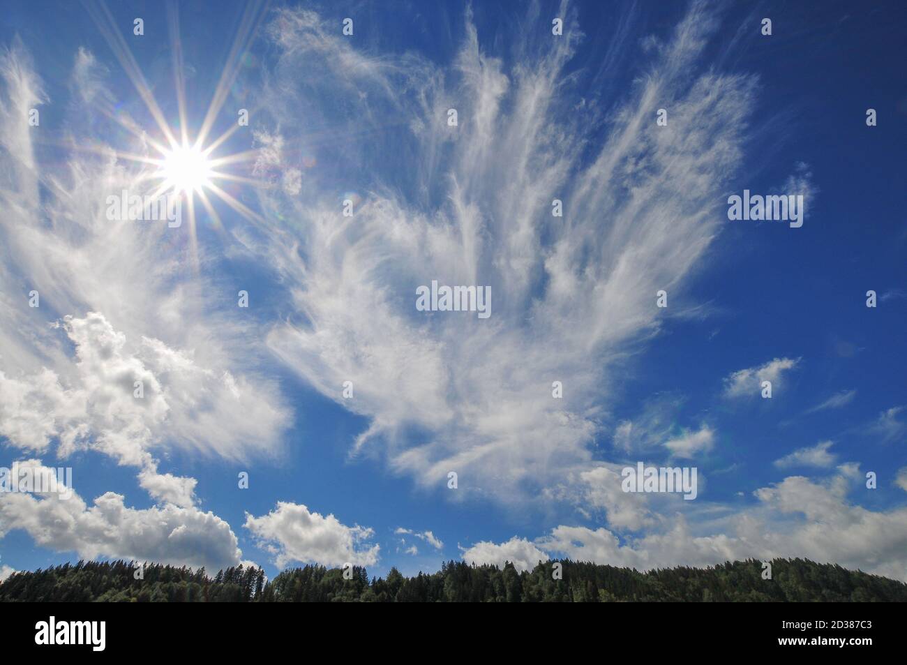 Backlit shot with sun star in the sky over the Allgäu, Bavaria, Germany Stock Photo