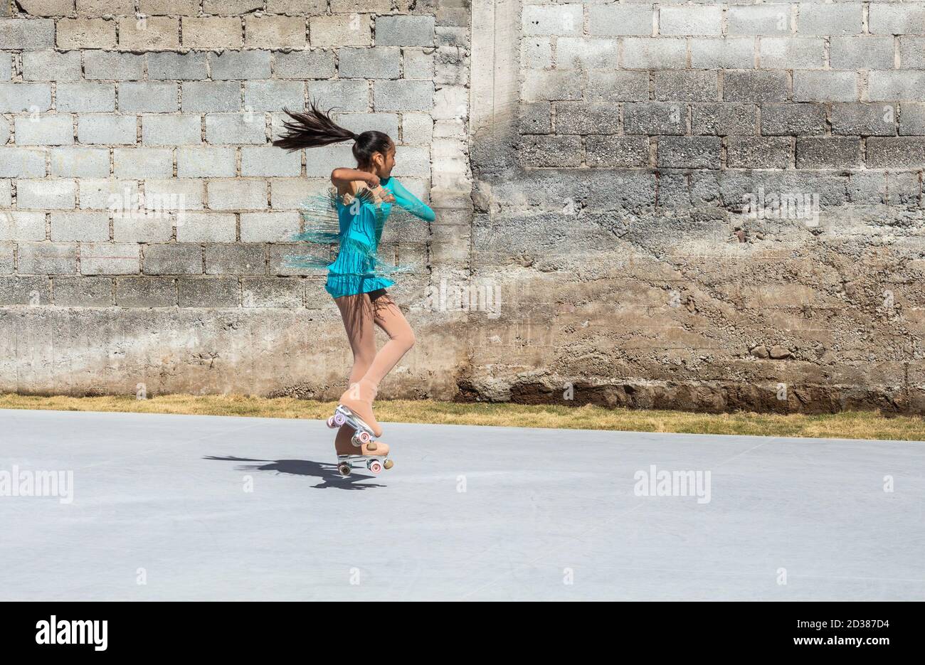 Teenage girl jumping on roller skates during a training session