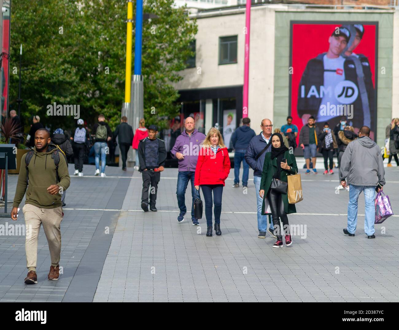 Members of the public walking down towards St Martins Church in Birmingham, near the Bull Ring Shopping centre Stock Photo