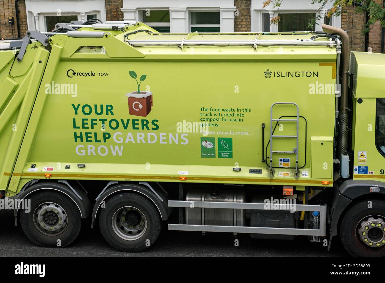 Recycling truck with slogan on side encouraging people to recycle food and green waste to make compost - Your Leftovers Help Gardens Grow - Islington Stock Photo