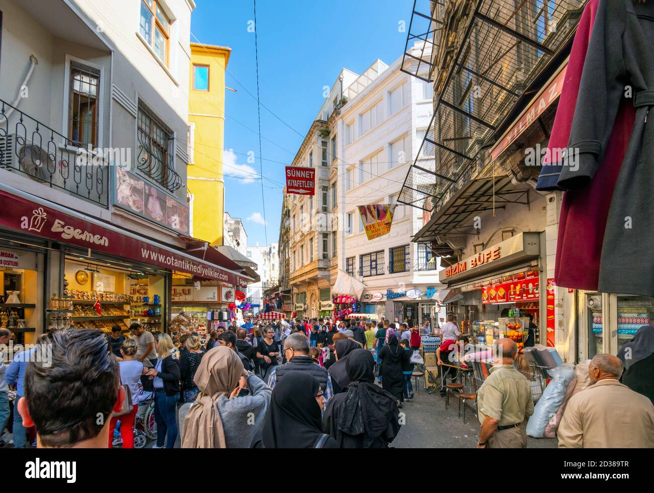Local Turks and tourists mix as they walk through the outdoor Eminonu Market in Istanbul, Turkey. Stock Photo