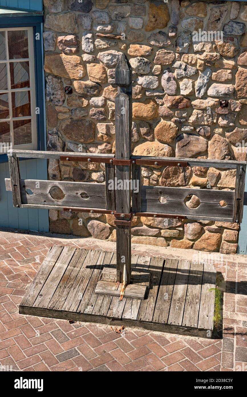 A set of wooden stocks, once used to humiliate and punish accused and condemned individuals. Stock Photo
