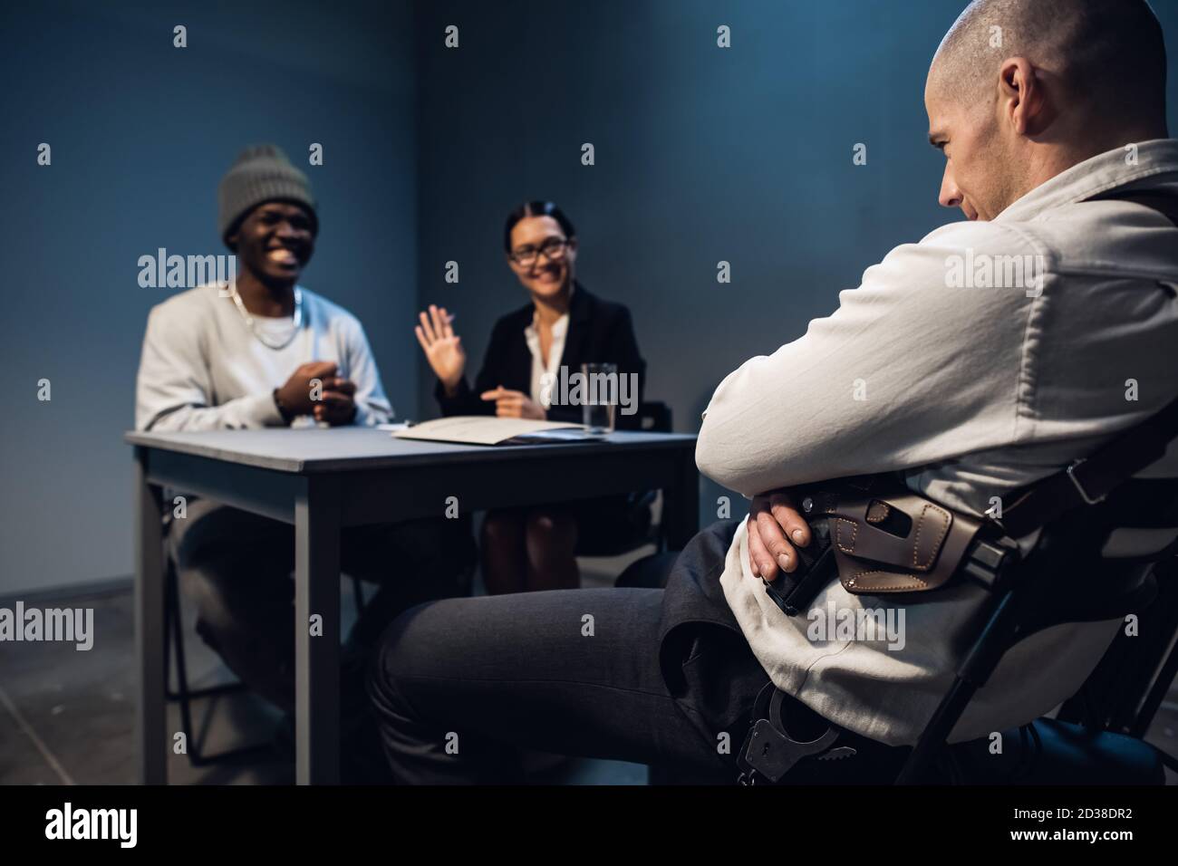Airport security has detained a black man with a package of cocaine and is conducting an interrogation in a specially equipped room. Stock Photo