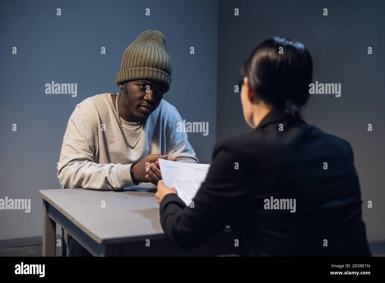 A lawyer girl with glasses and a young black guy communicate in the