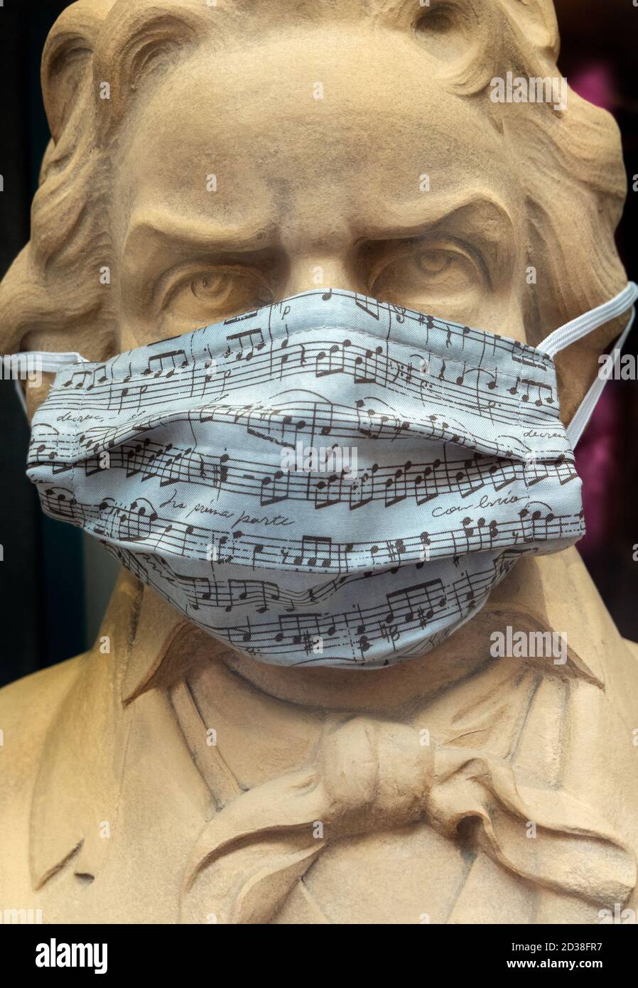 Beethoven statue bust wearing Covid Covid19 Corona face mask with musical score in Trier Germany 2020 Stock Photo